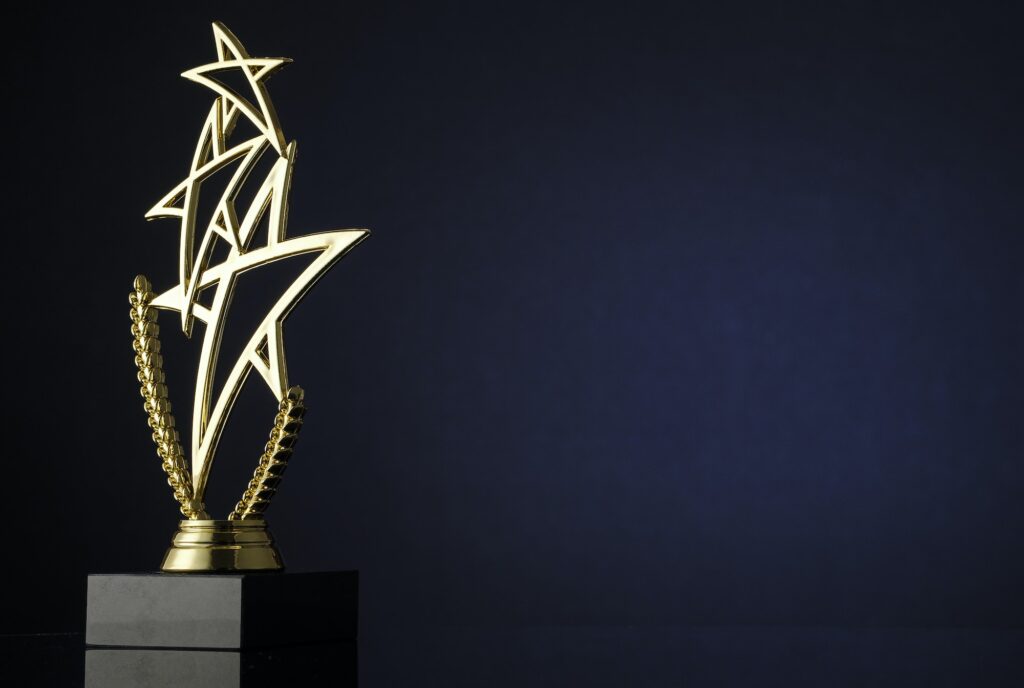 Stylish trophy with three gold stars and wreath